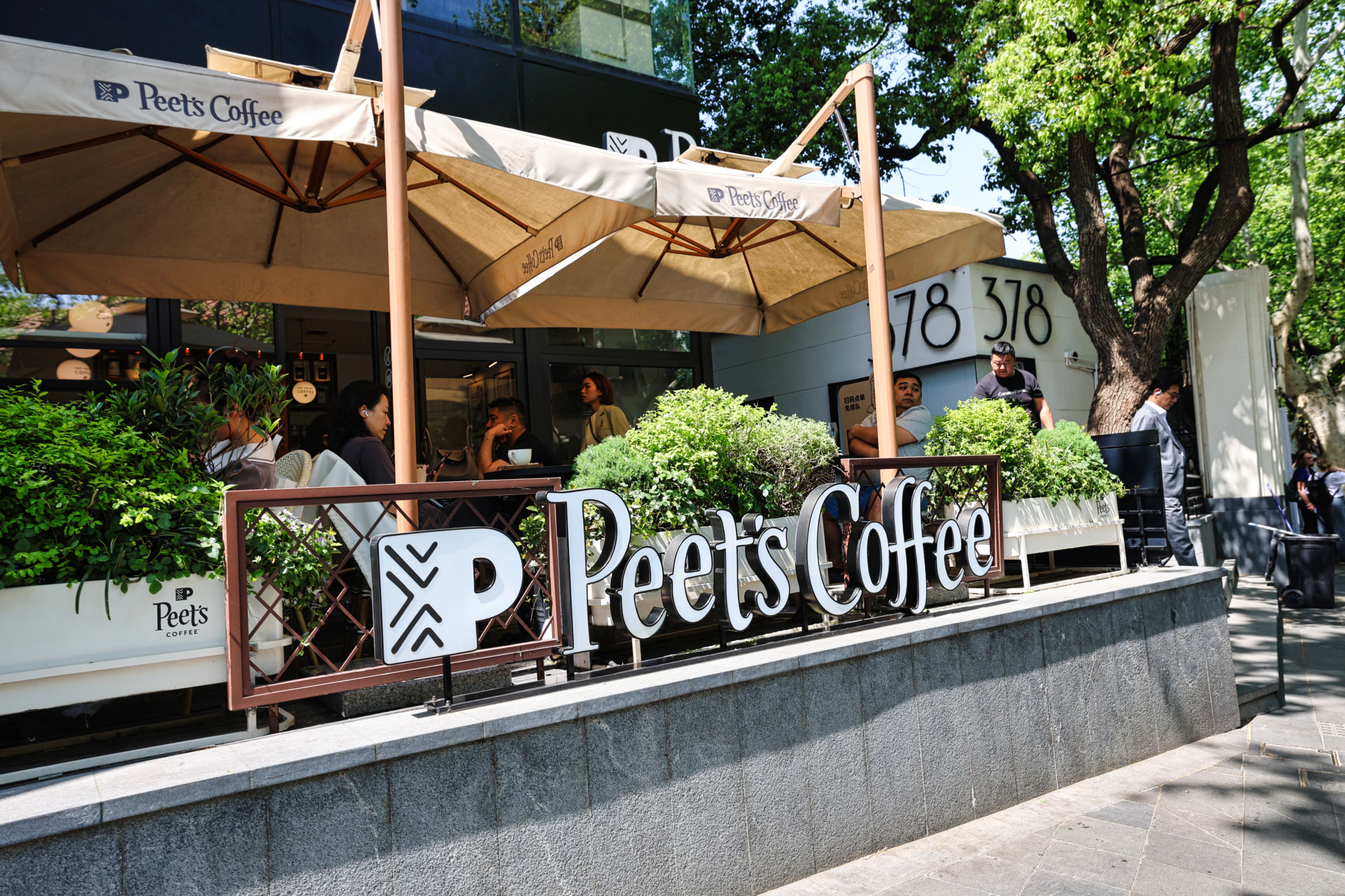Peet's Coffee storefront sign visible in a busy area