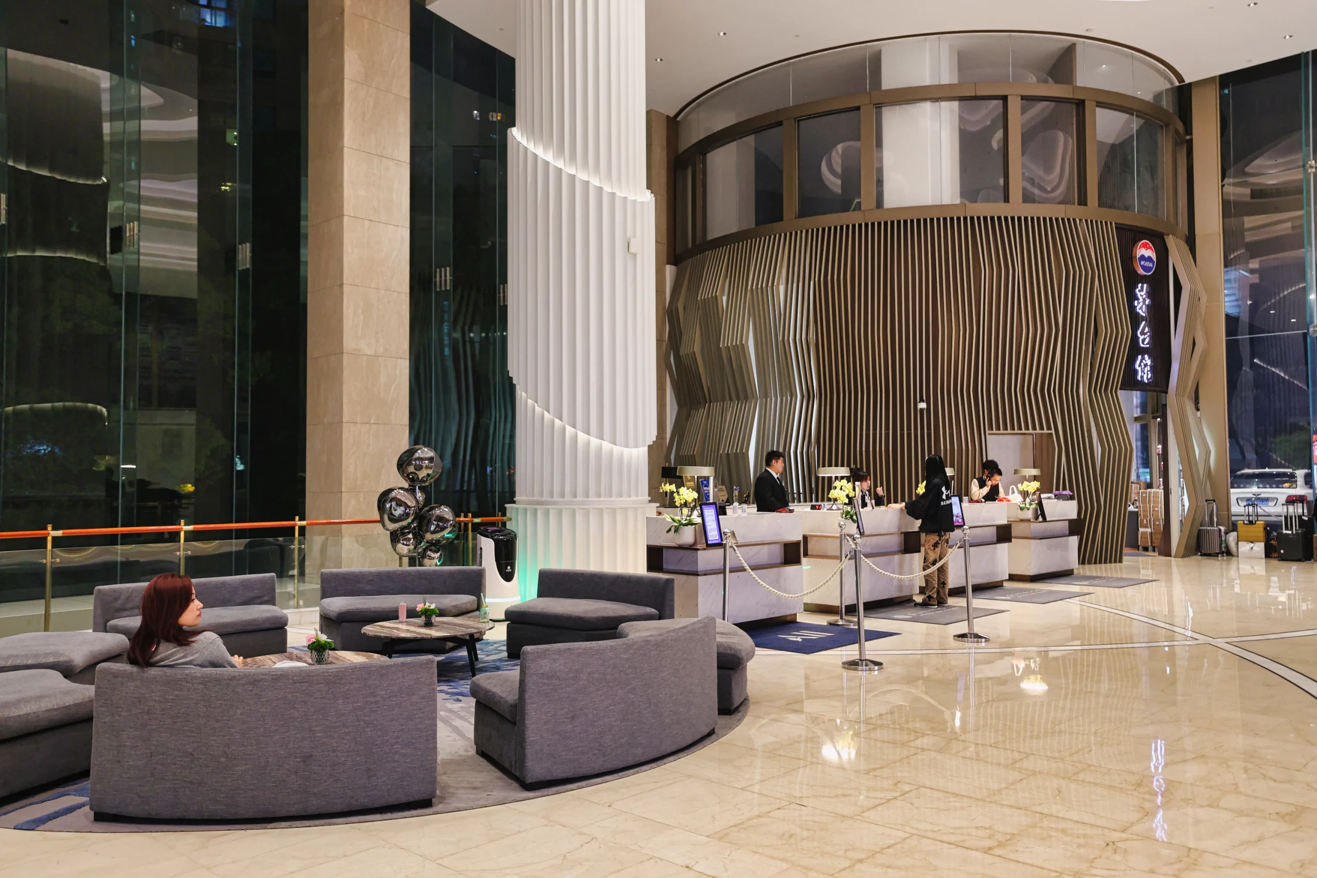 The front desk and check-in area of the hotel lobby.
