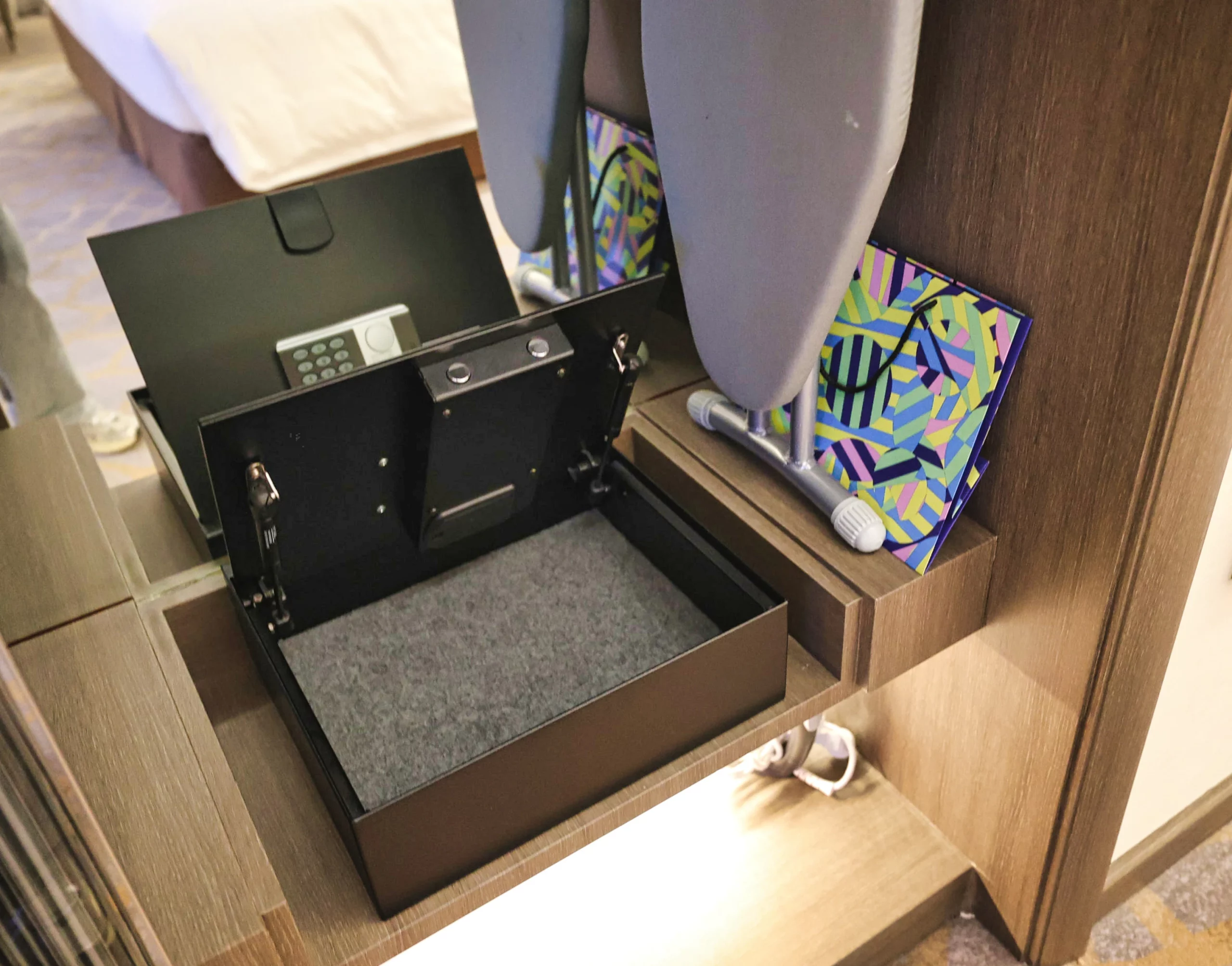 An open closet showing bathrobes and an umbrella.