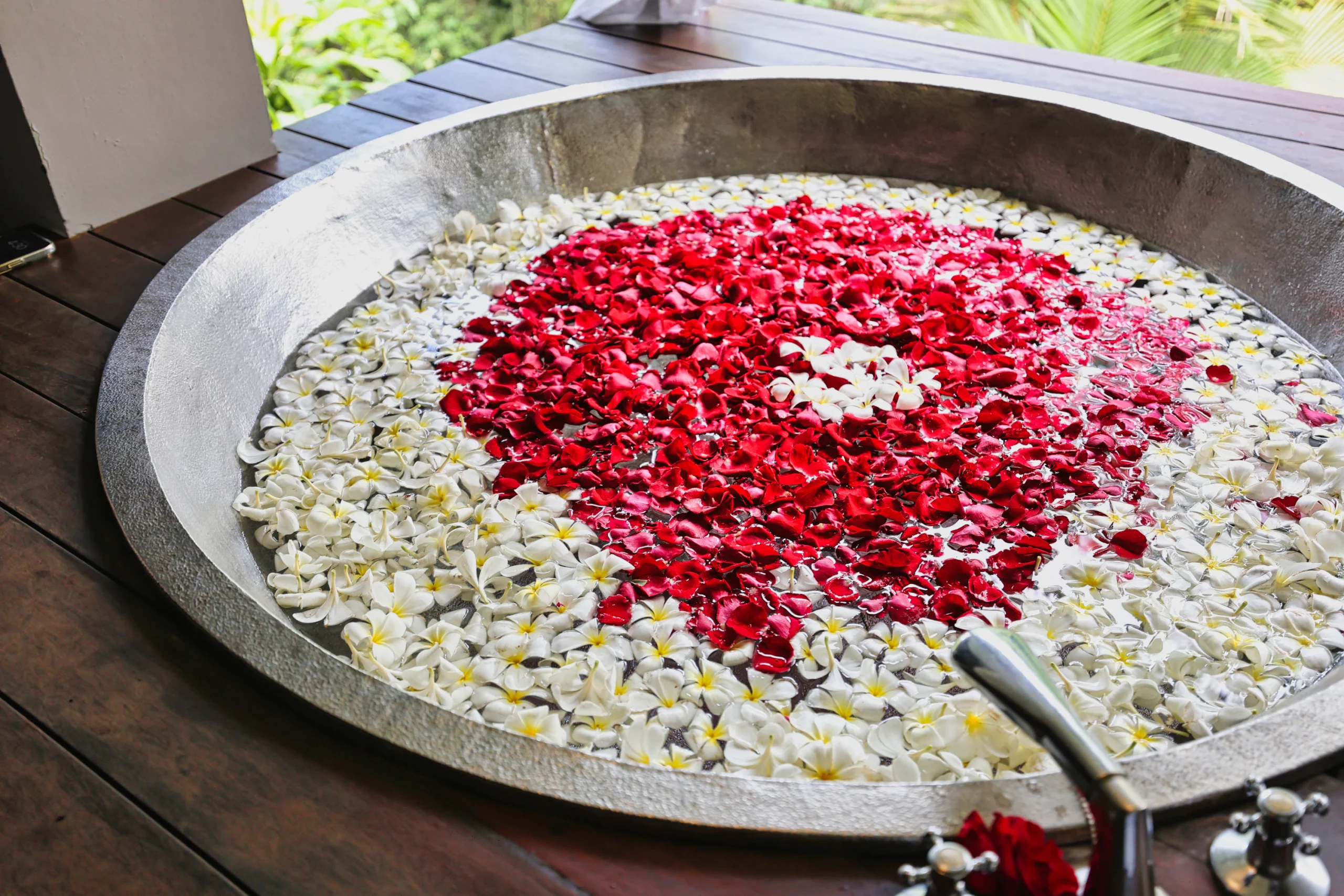 Luxurious bathtub filled with frangipani flowers