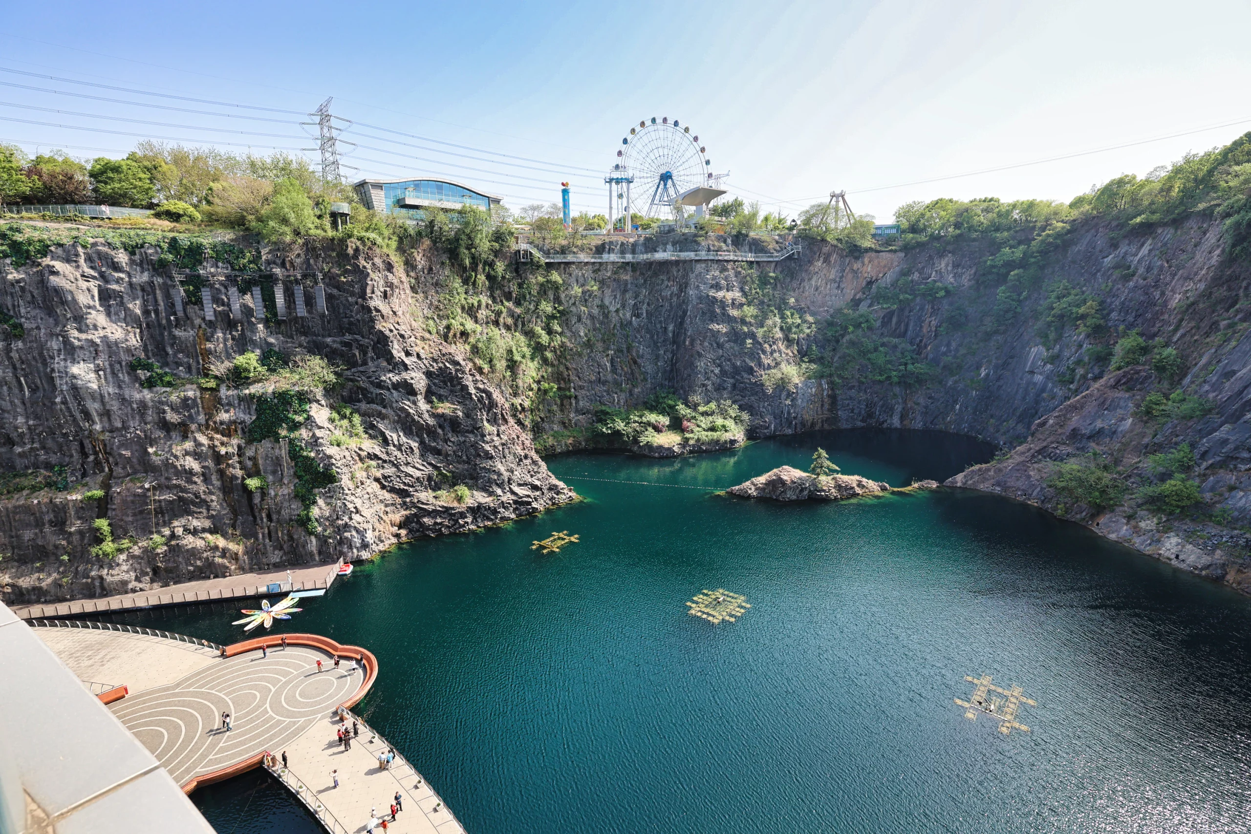Hotel balcony with a scenic view of a waterfall and lake.