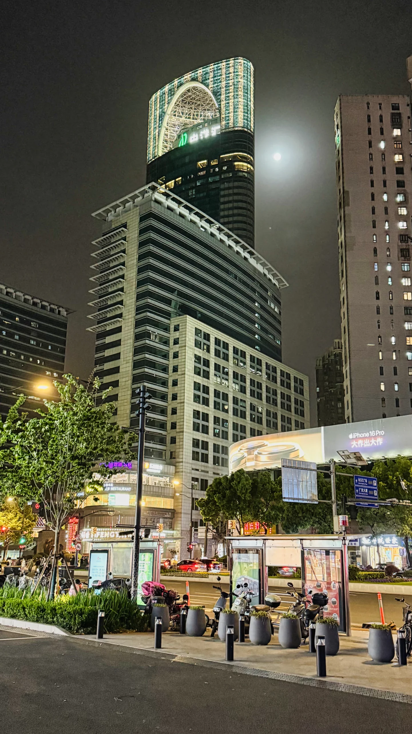 A nighttime view of the brightly lit shopping area near the hotel.