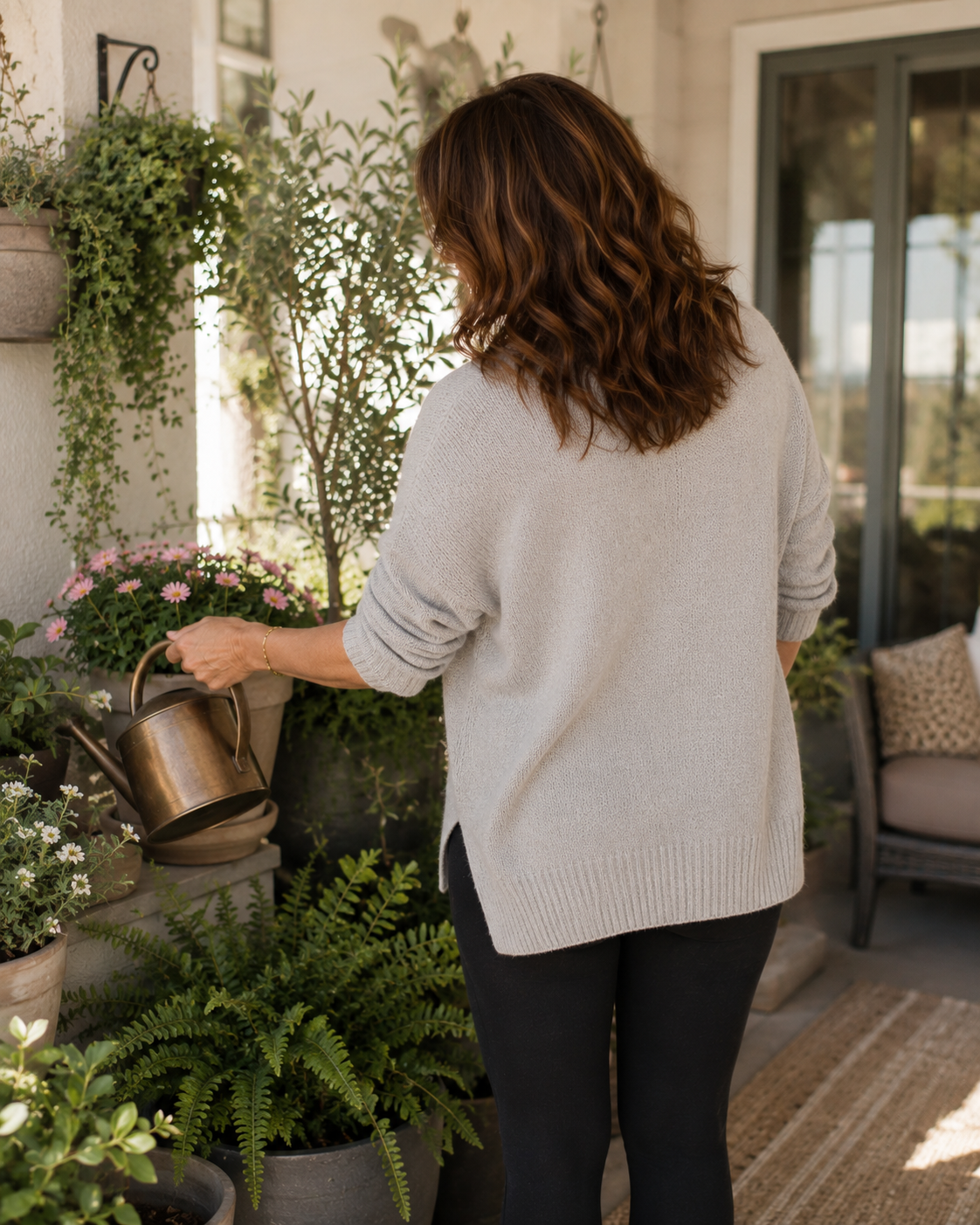 Grace tending the plants on her patio