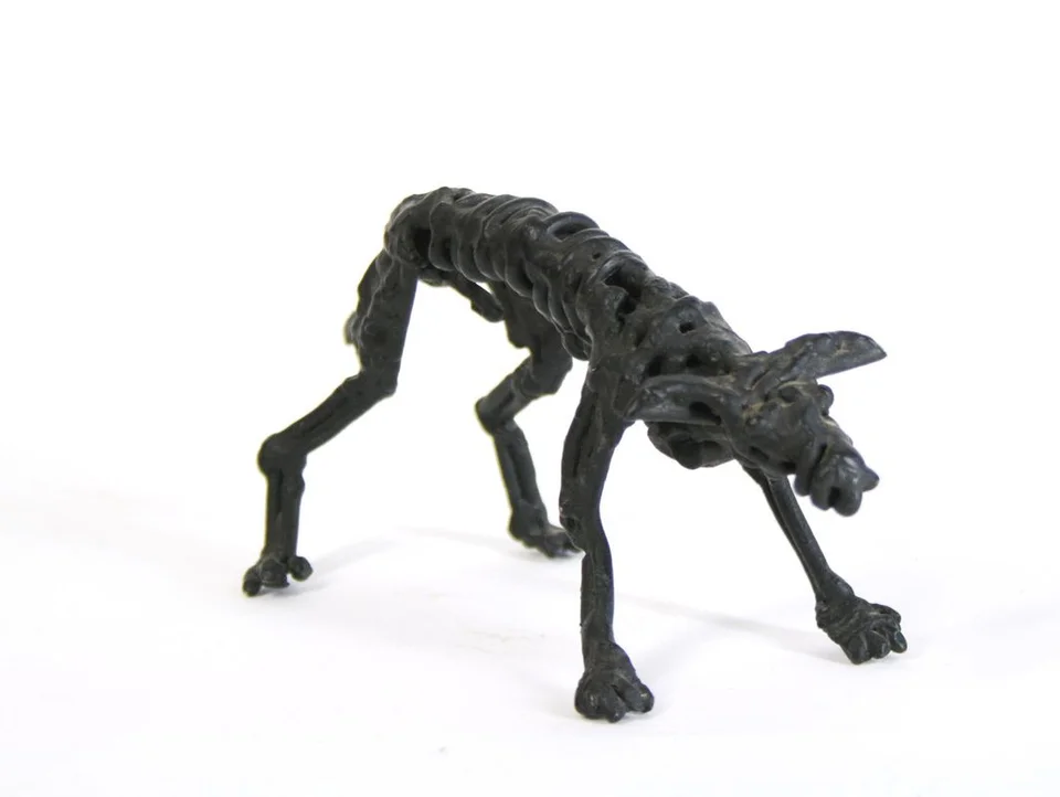 A small dog formed from twisted dark steel wire.