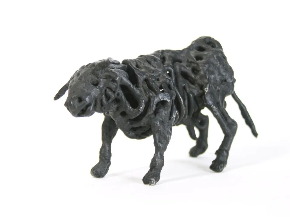 A bull formed from thick loops of dark welded steel.