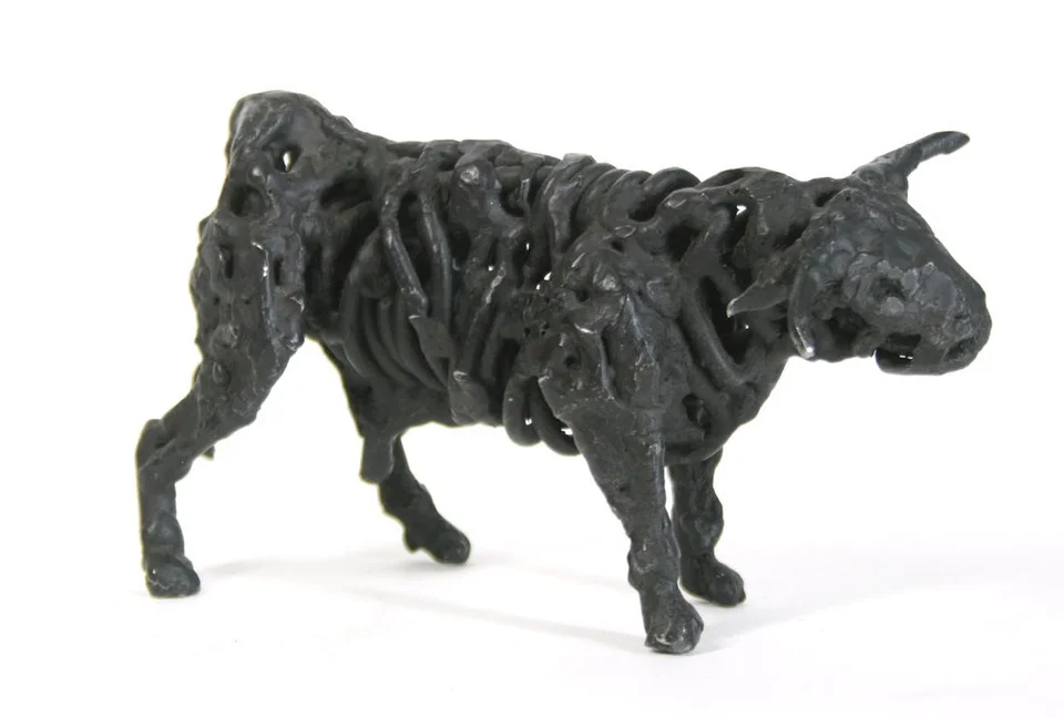 A bull formed from thick loops of dark welded steel.