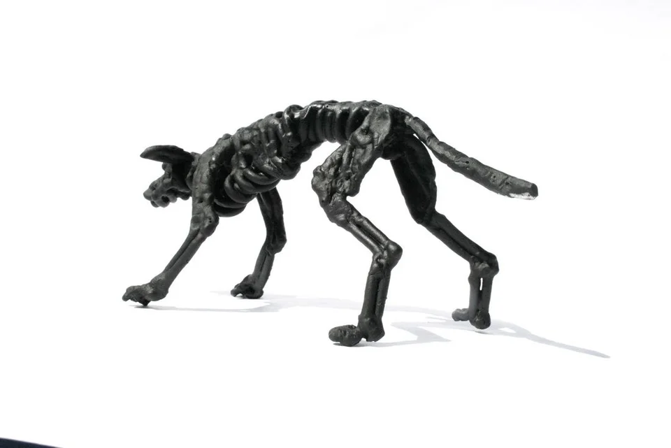 A small dog formed from twisted dark steel wire.