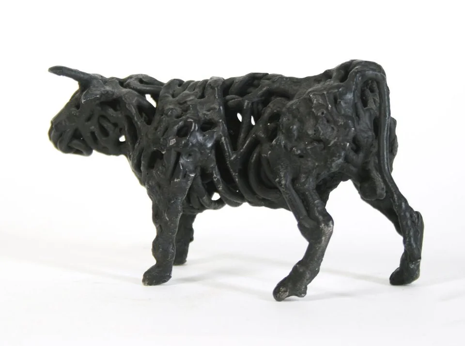 A bull formed from thick loops of dark welded steel.