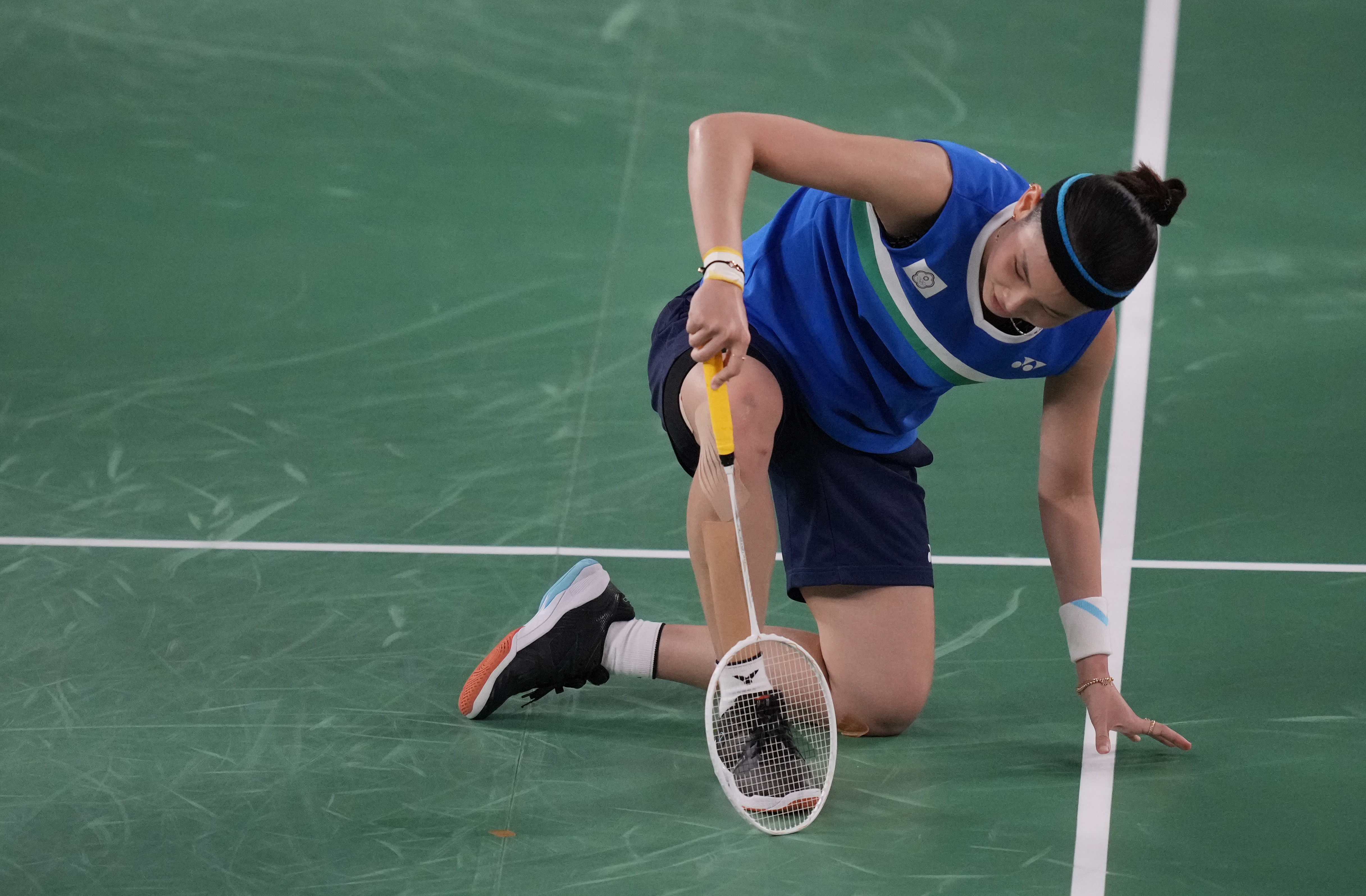 Taiwan's Tai Tzu-Ying gets up after slipping during a match against China's Chen Yu Fei in women's singles badminton gold medal match at the 2020 Summer Olympics, Sunday, Aug. 1, 2021, in Tokyo, Japan. (AP Photo/Dita Alangkara)