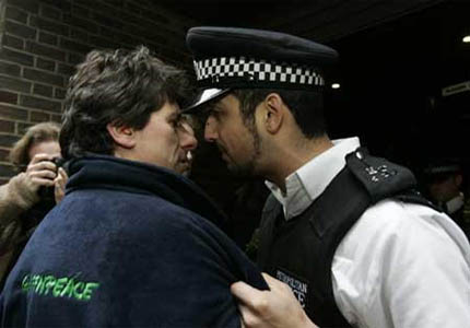 A policeman and a Greenpeace volunteer