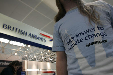 Greenpeace volunteers set up a climate ticket exchange in Gatwick airport