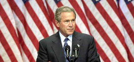 George Bush in front of the US flag