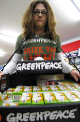 A Greenpeace volunteer offers free CFL light bulbs in a Southampton branch of Woolworths