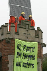 Greenpeace volunteers on John Prescott's roof, with the solar panels they kindly installed for him