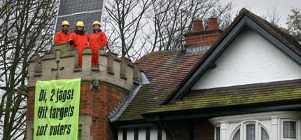 Greenpeace volunteers with solar panel on Prescott's roof