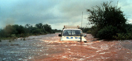 A UN jeep driving through flood water