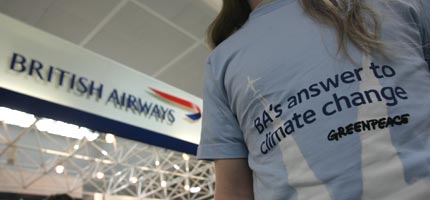 A Greenpeace activist at Gatwick Airport where passengers bound for Newquay were offered train tickets instead