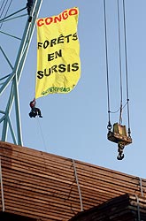 Greenpeace volunteers hang a banner from a crane at La Rochelle port in France