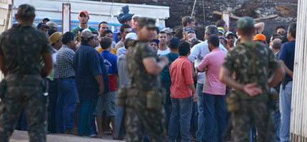 A mob led by loggers prevents Greenpeace activists from leaving Brazilian government offices