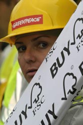 An activist with some FSC timber at Kelvingrove, Glasgow where illegal timber is being used in rennovations