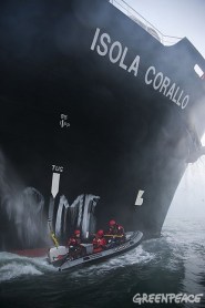 Greenpeace activists paint 'Forest Crime' on the hull of a palm oil tanker