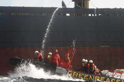 Activists try to board the MV Greveno to protest against ancient forest destruction