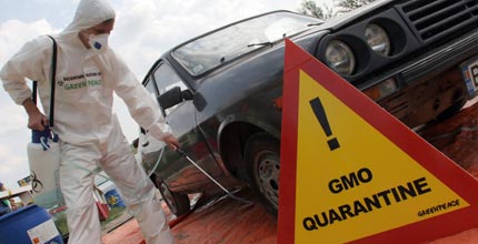 A Greenpeace volunteer sprays a car leaving Braila island, Romania