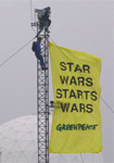 Greenpeace volunteers hang banner at Menwith Hill spy base, North Yorkshire