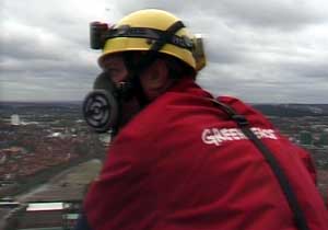 Greenpeace volunteer climber Mark Strutt on chimney at SELCHP