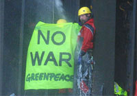 Greenpeace activist hangs from the military supply ship Lyra