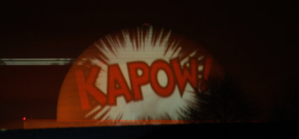 A giant KAPOW is projected onto the dome at Sizewell