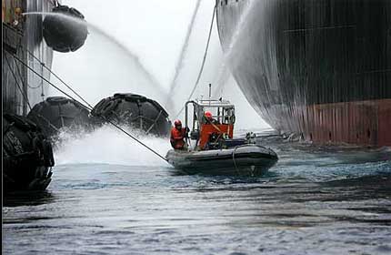 A Greenpeace infalatable delays refuelling of the whaling ship Nisshin Maru