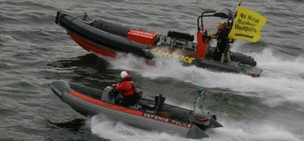 A police boat draws alongside a Greenpeace dinghy as the Faslane nuclear weapons submarine base is blockaded