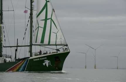 The Rainbow Warrior in front of Kent Flats Wind Farm