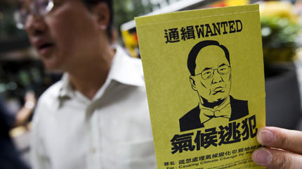 A sticker handed out in Hong Kong, calling chief executive Donald Tsang a 'climate fugitive'