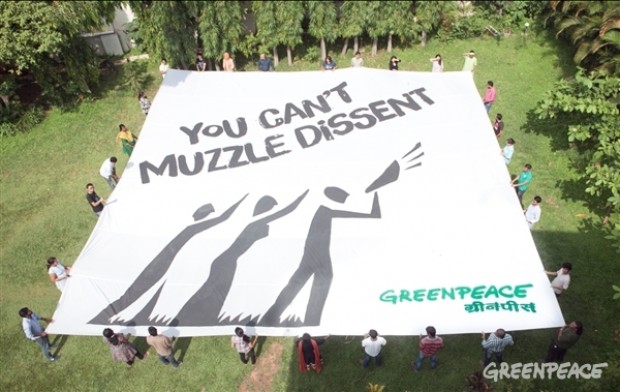 Activists hold a giant aerial banner saying 'You can't muzzle dissent!'