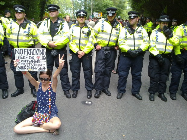 'No fracking here or anywhere' sign in front of police line