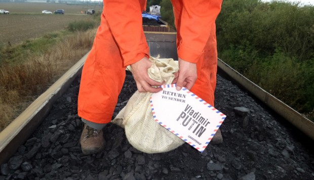Activist with a bag of coal from the train, with address label to Vladimir Putin