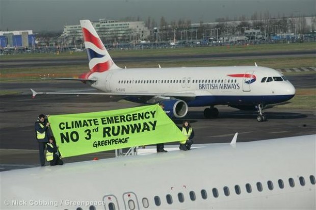 Greenpeace activists climb onto the top of a plane at London Heathrow Airport