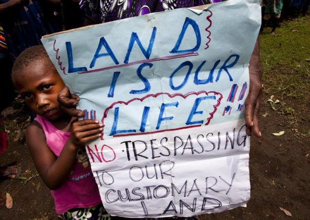 Child in Papua New Guinea protesting about land grabbing