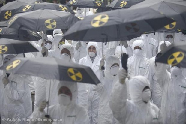 Greenpeace activists don radiation suits and parade through some of Jakarta's mo