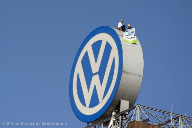 Greenpeace activists display a banner reading "CO2 Das Problem" at the VW factor