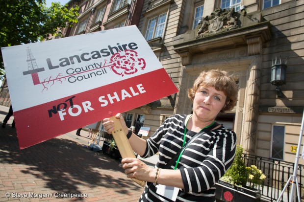 Greenpeace volunteer lobbying council with Fracking placard