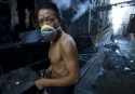 Daily workers at a denim washing factory in Xintang, China, search wastewater fo