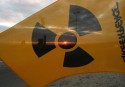 Setting sun shines through nuclear protest flag with radioactive symbol