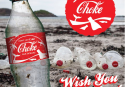 Picture of a Coke bottle on a beach