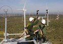 Technicians put up wind turbines in Spain