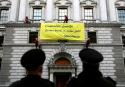 Greenpeace activists on the Treasury sending a message to Chancellor George Osbo