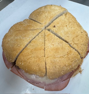 MUFFULATTA "NEW ORLEANS STYLE" WHOLE HAM, SALAMI, SWISS, ROMANO, PROVOLONE, OLIVE SALAD, ITALIAN DRESSING