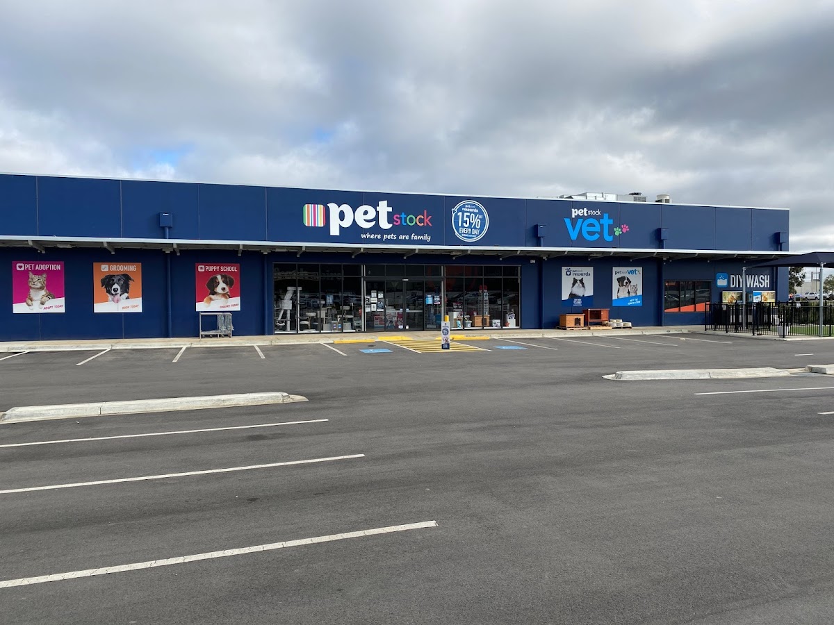 Exterior view of Petstock store with signage for pet adoption, grooming and puppy school.